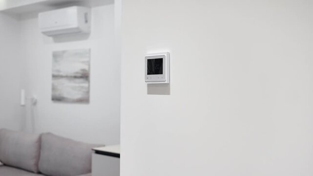 white thermostat for underfloor heating and climate control systems. control panel. apartment, house, hotel. smart home. automatic heating system. technology. stylish designer expensive repair