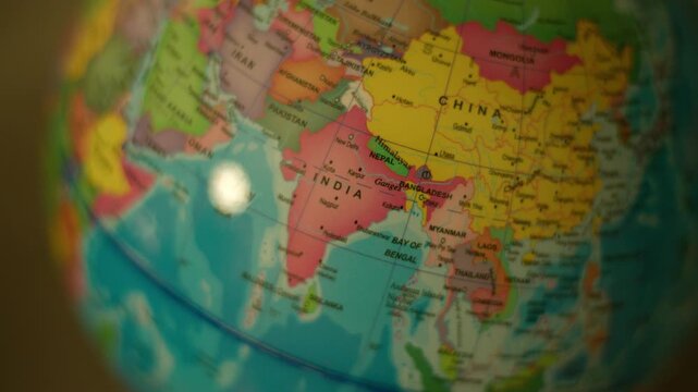 Globe spins slowly, highlighting India and surrounding nations. Soft focus emphasizes landmasses, oceans, and political boundaries. Ideal for educational, travel, or global business presentations