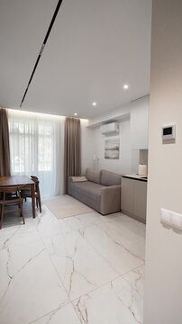 elegant kitchen living room with dining table in a modern renovated one-room apartment. elite hotel room. interior design, new renovation