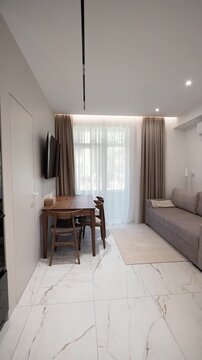 elegant kitchen living room with dining table in a modern renovated one-room apartment. elite hotel room. interior design, new renovation