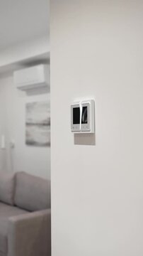 white thermostat for underfloor heating and climate control systems. control panel. apartment, house, hotel. smart home. automatic heating system. technology. stylish designer expensive repair