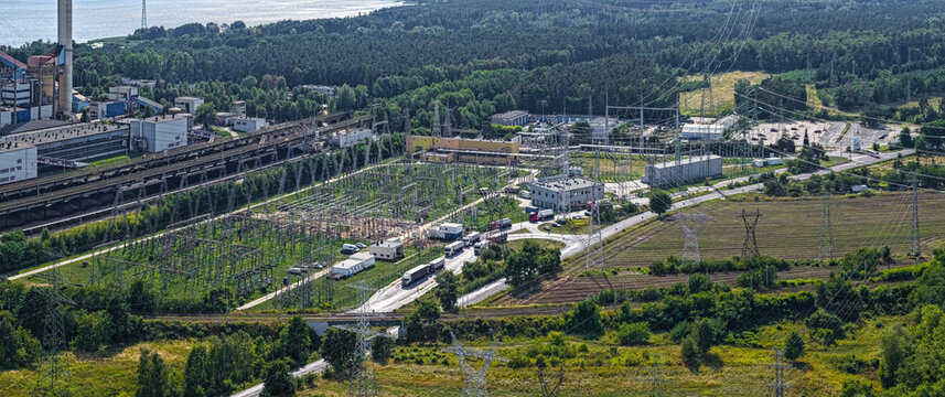 Aerial view of ZE PAK SA Patnow Power Plant featuring an electrical substation, power lines, and industrial infrastructure near the lake in Konin, Wojewodztwo wielkopolskie, Poland.