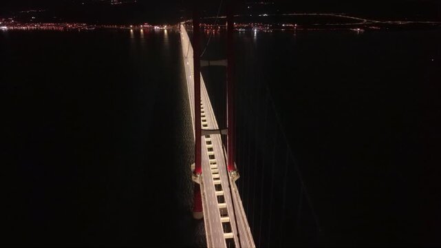 Aerial night view of the illuminated 1915 &Ccedil;anakkale Bridge spanning the Dardanelles Strait in Turkey, a monumental suspension bridge connecting Europe and Asia across the historic waterway.