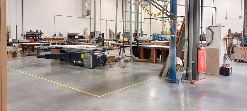 EDMONTON, ALBERTA, CANADA - 31 OCTOBER, 2023. Industrial Altendorf sliding table saw machine inside a modern woodworking factory.
