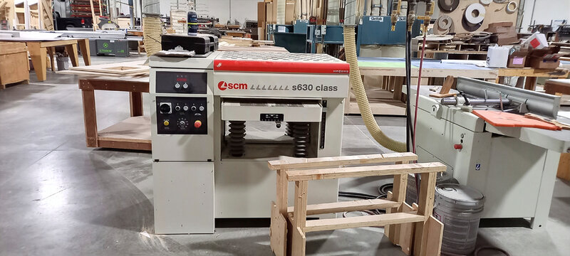 EDMONTON, ALBERTA, CANADA - 01 NOVEMBER, 2023. SCM s630 class thickness planer machine inside a commercial woodworking factory.