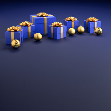 Blue gift boxes with golden ribbon and bow and christmas baubles on a blue stone background. Copy space