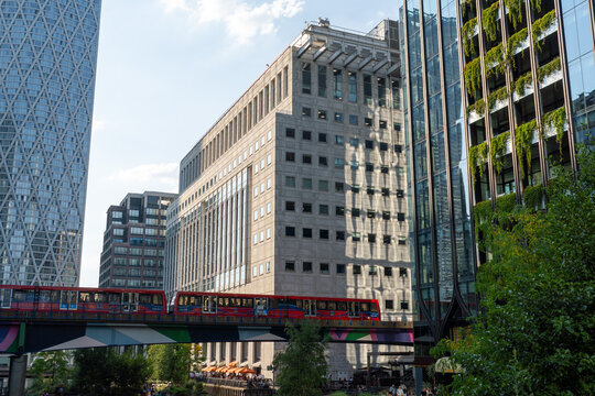Urban Cityscape Featuring Skyscrapers and Train on Elevated Track in Daylight