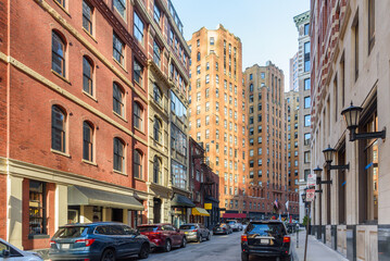 Renovated tradtional high rise buildings with shops on ground floor along a narrow street with...