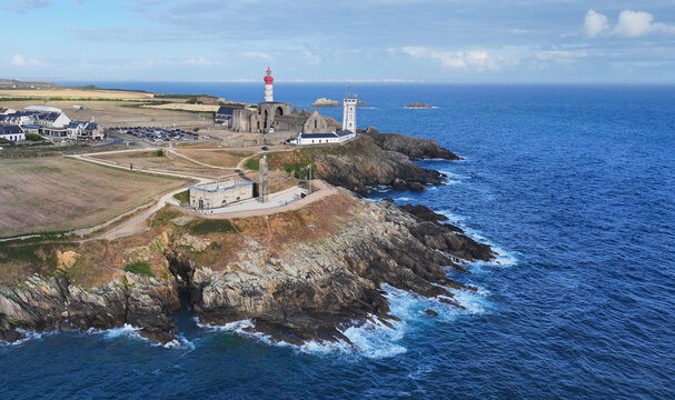 Aerial view of Pointe Saint-Mathieu featuring the historic lighthouse and abbey ruins on a rugged cliff overlooking the Atlantic Ocean in Plougonvelin, Brittany, France.