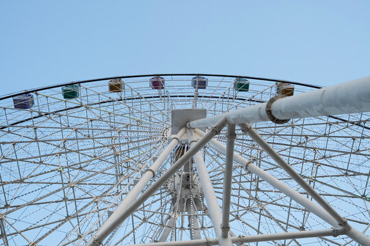 Ferris Wheel Structure Against Clear Blue Sky from Low Angle