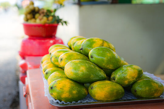 Fresh Green and Yellow Mangoes Displayed at a Local Market