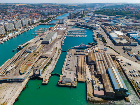 Aerial view of Port de Boulogne-sur-Mer featuring the marina, industrial harbor facilities, and docked ships in Boulogne-sur-Mer, Hauts-de-France, France.