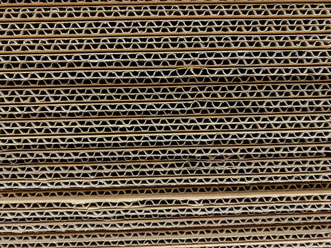 Stack of corrugated cardboard layers showing fluted paper texture