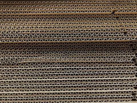 Horizontal stack of corrugated cardboard with repeating fluted pattern