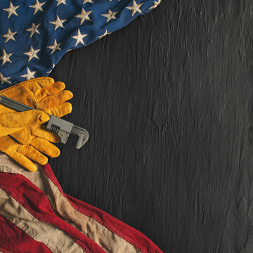 Work gloves with the American flag on black background. Symbolic of blue collar workers, USA manufacturing, pride in products Made in United States of America, or for Father's day or US Labor Day.