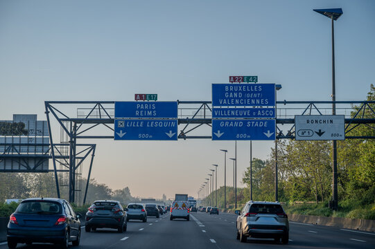 View of a French and European autoroute with overhead directional signs pointing to major cities like Paris, Bordeaux, Lille, Calais, showing lanes, traffic and motorway infrastructure, road signes
