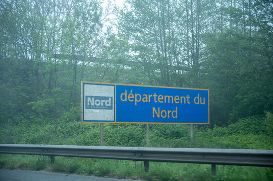 View of a French and European autoroute with overhead directional signs pointing to major cities like Paris, Bordeaux, Lille, Calais, showing lanes, traffic and motorway infrastructure, road signes