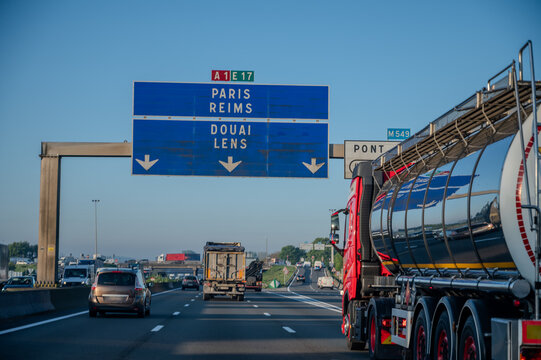 View of a French and European autoroute with overhead directional signs pointing to major cities like Paris, Bordeaux, Lille, Calais, showing lanes, traffic and motorway infrastructure, road signes