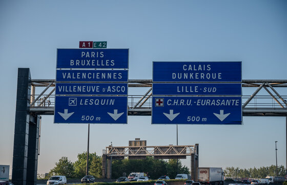 View of a French and European autoroute with overhead directional signs pointing to major cities like Paris, Bordeaux, Lille, Calais, showing lanes, traffic and motorway infrastructure, road signes