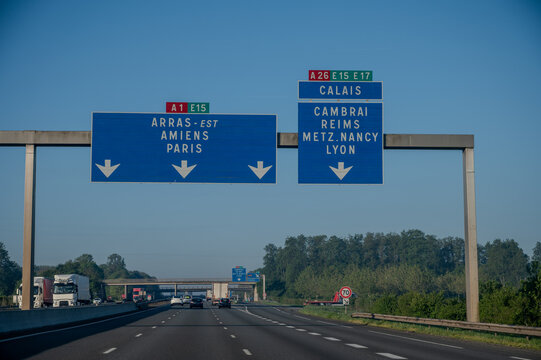 View of a French and European autoroute with overhead directional signs pointing to major cities like Paris, Bordeaux, Lille, Calais, showing lanes, traffic and motorway infrastructure, road signes