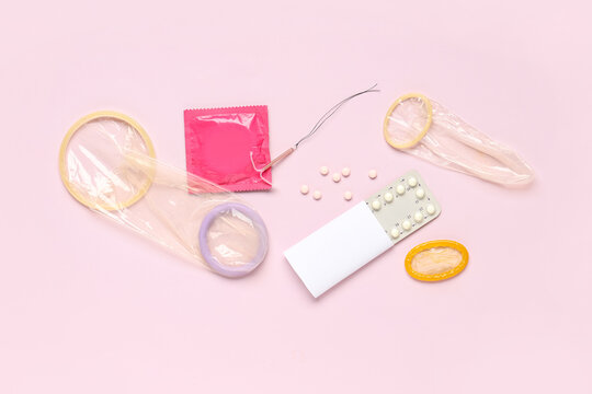 Various Birth control methods including condoms, oral contraceptive pills, and an IUD on a pink background