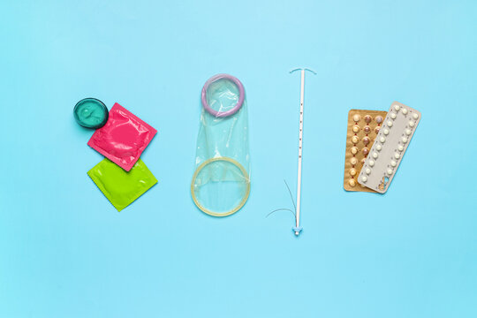 Various birth control methods including condoms IUD and oral contraceptive pills on a blue background family planning, this collection different options for family planning and sexual health