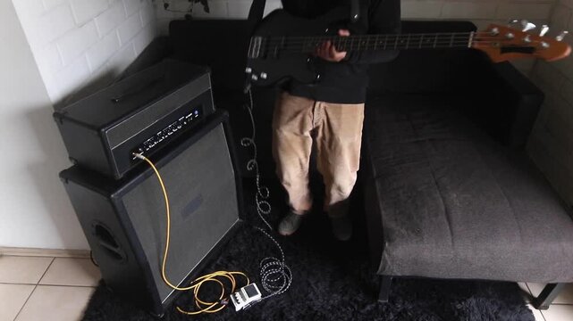 A man gets ready to practice on his electric bass