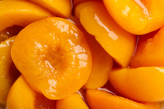 Texture of sweet canned peaches as background