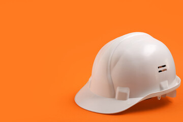 Fototapeta premium White hardhat on orange background