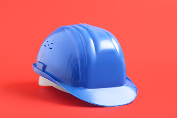 Fototapeta premium Blue hardhat on red background