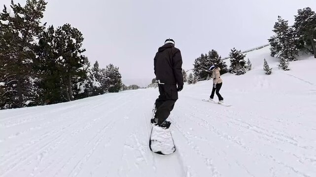 Snowboarder gliding down a snowy mountain slope