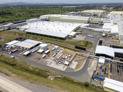 Aerial view of a large car factory complex with expansive industrial buildings, parking lots, and logistics infrastructure in San Luis Potosi, San Luis Potosi, Mexico.
