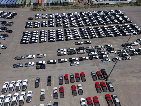 Aerial view of a car factory parking lot filled with rows of new pickup trucks in San Luis Potosi, San Luis Potosi, Mexico.