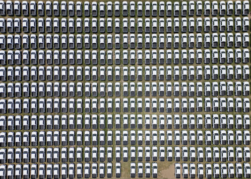 Aerial view of a car factory lot filled with rows of new white pickup trucks in San Luis Potosi, San Luis Potosi, Mexico.