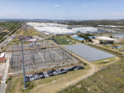 Aerial view of the General Motors car factory featuring extensive production facilities, rows of parked vehicles, and an electrical substation in San Luis Potosi, San Luis Potosi, Mexico.