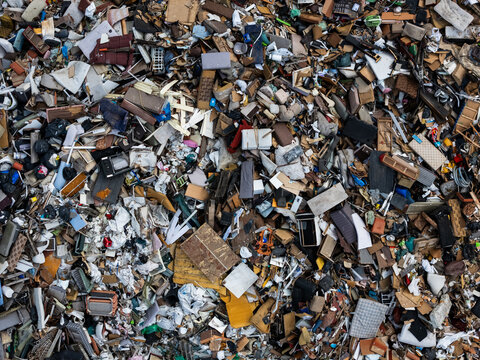 Aerial view of a large landfill site filled with various types of waste, including plastic and discarded household items in Klaipeda, Klaipeda County, Lithuania.