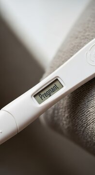 Close up of a positive pregnancy test result.