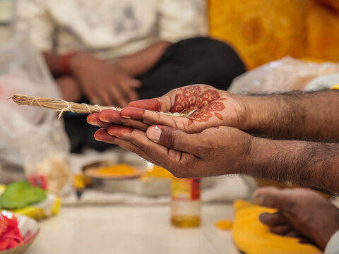 Close-up of Couple Performing Rituals in Traditional Hindu Wedding Ceremony Indian Groom and Bride Holding Sacred Darbha Grass During Hindu Wedding Rituals