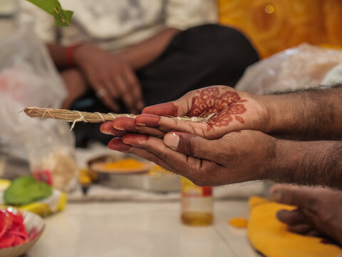 Close-up of Couple Performing Rituals in Traditional Hindu Wedding Ceremony Indian Groom and Bride Holding Sacred Darbha Grass During Hindu Wedding Rituals