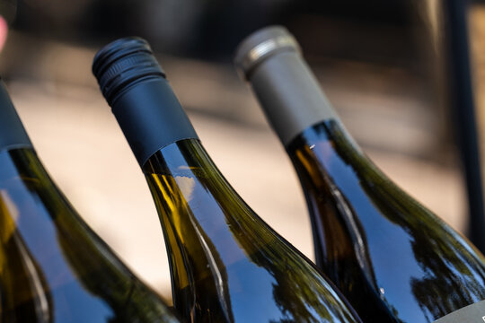 Close-up of a few white wine bottles.