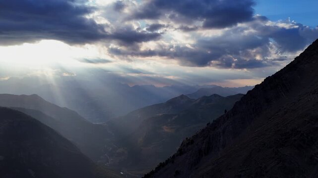 Aerial hyperlapse captured during the partial solar eclipse of August 2026. Clouds and mist drift over the mountain ridges of the Hautes-Alpes as the light dims. Stabilized drone footage, ideal for do