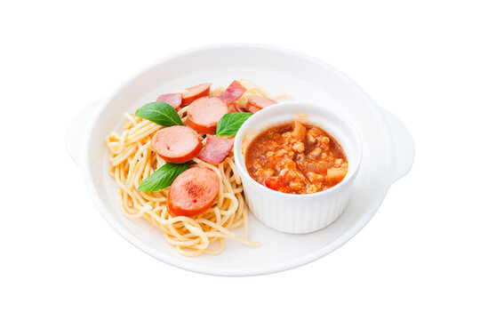homemade spaghetti with separated sauce on white plate isolated on white background, clipping path included, Italian cuisine