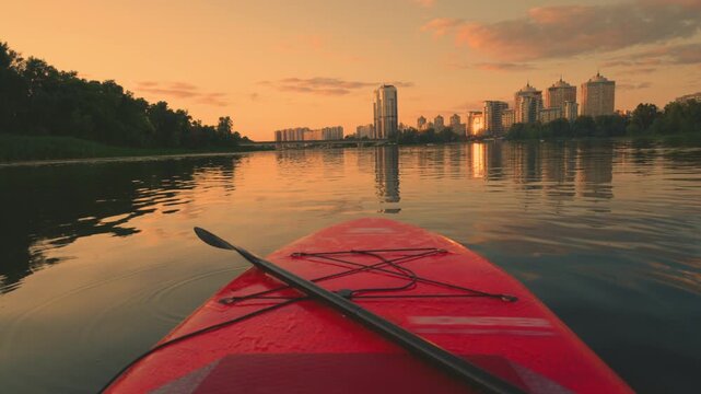 Paddle Board Gliding on River Toward City Skyline at Sunset | POV Video of Warm Golden Hour Water Journey | Urban Outdoor Recreation