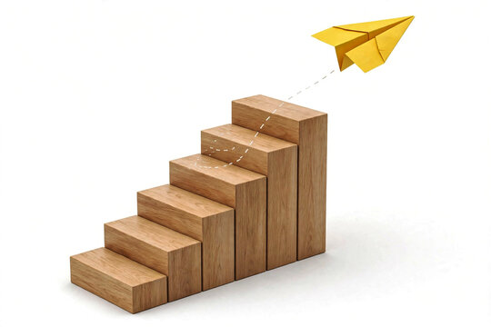 Wooden Toy Blocks Stacked as Rising Staircase with Yellow Paper Plane Flying High on White Background for Step by Step Business Growth Startup Launch Innovation and Freedom Concept