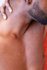 Naklejka premium Close-up of a person's shoulder and neck, hand resting on the back.