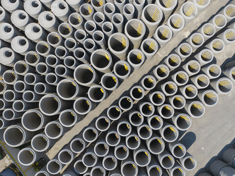 Aerial view of concrete pipes and manhole sections with yellow ladders stored at the Bruk-Bet production facility in Tarnow, Malopolskie, Poland.