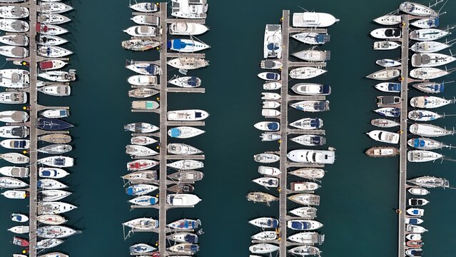 Aerial view of numerous sailboats and yachts docked in parallel rows at the marina in Santa Cruz de Tenerife, Canary Islands, Spain.