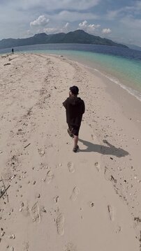 Slow Motion of Person Walking on a Tropical Island Beach