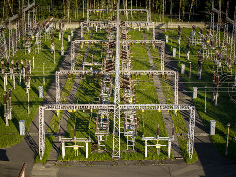 Aerial view of GPZ Trzebinia electrical substation with metal structures, power lines, and green grass in Trzebinia, Lesser Poland Voivode, Poland.