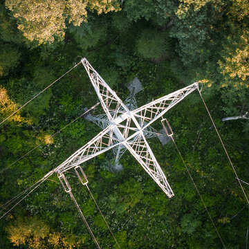 Aerial view of GPZ Trzebinia transmission tower surrounded by dense green forest canopy in Trzebinia, Lesser Poland Voivode, Poland.